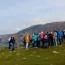 A group of people overlooking the majestic, cliff-lined seascape with Sliabh Liag Tours.